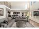 Open-concept living room and kitchen boasts high ceilings, natural light, and a comfortable sectional at 22870 E Chenango Ave, Aurora, CO 80015