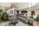 Open-concept living room featuring a spacious layout, staircase and seamless flow into kitchen and dining areas at 22870 E Chenango Ave, Aurora, CO 80015