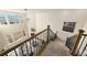 Open-concept living room viewed from above the staircase, featuring natural light and a cozy fireplace at 22870 E Chenango Ave, Aurora, CO 80015