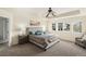Comfortable main bedroom features an upholstered bed, neutral tones, and natural light at 22870 E Chenango Ave, Aurora, CO 80015