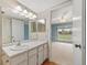 Bathroom vanity with double mirrors and open bedroom entrance at 6495 E Happy Canyon Rd # 171, Denver, CO 80237