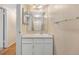 Bathroom with updated vanity, shower, and large mirror at 6495 E Happy Canyon Rd # 171, Denver, CO 80237