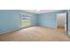 Spacious bedroom featuring large window with scenic backyard views and neutral carpeting at 6495 E Happy Canyon Rd # 171, Denver, CO 80237