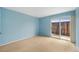 Cozy bedroom featuring natural light and sliding door to the outdoors at 6495 E Happy Canyon Rd # 171, Denver, CO 80237