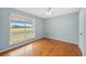 Bright bedroom showcasing a large window and wood floors at 6495 E Happy Canyon Rd # 171, Denver, CO 80237