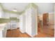 Bright kitchen with white appliances, ample cabinetry, and hardwood floors at 6495 E Happy Canyon Rd # 171, Denver, CO 80237