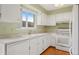 Bright kitchen featuring white cabinets, Formica countertop and appliances, and hardwood floors at 6495 E Happy Canyon Rd # 171, Denver, CO 80237