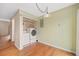 A dedicated laundry space with washer and dryer, convenient shelving, hardwood floors and easy access at 6495 E Happy Canyon Rd # 171, Denver, CO 80237