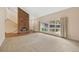 Bright living room features a large picture window, brick fireplace and a staircase leading to a second level at 6495 E Happy Canyon Rd # 171, Denver, CO 80237