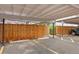 Assigned parking space with wooden divider in a covered carport at 6495 E Happy Canyon Rd # 171, Denver, CO 80237