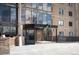 Exterior of a tan brick building with a covered entrance and landscaped surroundings at 7865 E Mississippi Ave # 608, Denver, CO 80247