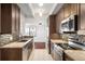 Well-lit kitchen with stainless steel appliances, granite countertops, and backsplash at 7865 E Mississippi Ave # 608, Denver, CO 80247