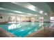 Indoor pool surrounded by lounge chairs, windows, and plenty of natural light at 7865 E Mississippi Ave # 608, Denver, CO 80247