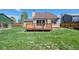 View of back of house featuring the deck and backyard with lush lawn area at 714 Sedge Way, Lafayette, CO 80026