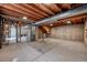 Unfinished basement with concrete floor, exposed wood ceiling and utility area at 714 Sedge Way, Lafayette, CO 80026