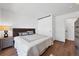 Bright bedroom with wood floors, a comfortable bed with a headboard, and a closet with sliding doors at 714 Sedge Way, Lafayette, CO 80026