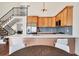 Modern kitchen featuring stainless steel appliances, wood cabinets, and a large island with white countertop and seating at 714 Sedge Way, Lafayette, CO 80026