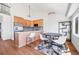 Open kitchen and dining area features stainless steel appliances, ample cabinetry, and a breakfast bar at 714 Sedge Way, Lafayette, CO 80026