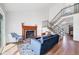Bright living room featuring a fireplace, staircase with black metal railings, and views to the exterior at 714 Sedge Way, Lafayette, CO 80026