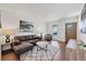 Stylish living room featuring a comfortable sofa, wood floors, and bright natural light at 714 Sedge Way, Lafayette, CO 80026