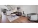 Modern living room with sleek furniture, hardwood floors, and a staircase at 714 Sedge Way, Lafayette, CO 80026