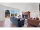 Cozy living room with fireplace, comfortable seating, and sliding glass doors to deck at 714 Sedge Way, Lafayette, CO 80026