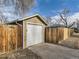 Single-car detached garage with a driveway and fenced yard at 2095 S Knox Ct, Denver, CO 80219