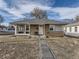 Charming ranch home with a well-maintained lawn and walkway at 2095 S Knox Ct, Denver, CO 80219