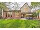 Spacious backyard with brickwork, patio, outdoor dining area, and manicured lawn at 5390 S Geneva St, Englewood, CO 80111