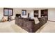 Open basement layout with a sectional sofa, custom built-in shelves, and media setup at 5390 S Geneva St, Englewood, CO 80111