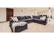 Spacious finished basement featuring a large sectional sofa and neutral carpeting at 5390 S Geneva St, Englewood, CO 80111
