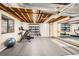 Home gym in the basement with exercise bike, weights, mirror, and rubber floor at 5390 S Geneva St, Englewood, CO 80111