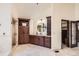 Bright bathroom featuring a large vanity, stone countertop, and custom storage cabinets with an oversized round mirror at 5390 S Geneva St, Englewood, CO 80111
