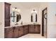 Bathroom featuring granite countertops, dual sinks, and dark cabinets at 5390 S Geneva St, Englewood, CO 80111