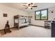 Neutral bedroom with a bunk bed, a ceiling fan, and a large window, creating a cozy and functional space at 5390 S Geneva St, Englewood, CO 80111