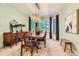 The dining room offers natural light, a wood table, and elegant furnishings at 5390 S Geneva St, Englewood, CO 80111
