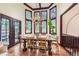 Bright dining room features large windows, wood beams, and a rustic chandelier at 5390 S Geneva St, Englewood, CO 80111