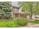 Charming two-story home with a well-maintained lawn and brick and stone accents at 5390 S Geneva St, Englewood, CO 80111
