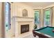 Game room featuring a fireplace, bay windows, and a pool table at 5390 S Geneva St, Englewood, CO 80111