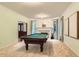 Game room features a pool table, fireplace, and ample natural light at 5390 S Geneva St, Englewood, CO 80111