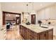 Spacious kitchen with a large center island, granite countertops, stainless steel appliances, and an open floor plan at 5390 S Geneva St, Englewood, CO 80111
