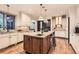 Spacious kitchen with granite countertops, a large center island with seating, and modern appliances at 5390 S Geneva St, Englewood, CO 80111