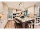 Spacious kitchen with a large center island, granite countertops, stainless steel appliances, and hardwood floors at 5390 S Geneva St, Englewood, CO 80111