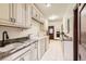 A bright laundry room featuring white cabinets, granite countertops, washer, dryer, and tile flooring at 5390 S Geneva St, Englewood, CO 80111