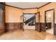 Living room with beautiful wood trim, leading to the staircase and a view of the bathroom through double doors at 5390 S Geneva St, Englewood, CO 80111