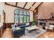Spacious living room with vaulted ceiling, brick fireplace, and large windows at 5390 S Geneva St, Englewood, CO 80111