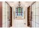 A luxurious bathroom with a soaking tub, chandelier, and and closets at 5390 S Geneva St, Englewood, CO 80111