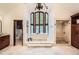 A luxurious bathroom with a soaking tub, vaulted ceilings, and shower at 5390 S Geneva St, Englewood, CO 80111