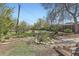Private backyard featuring garden beds, lush greenery, and ample space for gardening and recreation at 2022 S Clay St, Denver, CO 80219