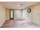 Basement area with laminate floors, bright lighting, and door to the backyard at 2022 S Clay St, Denver, CO 80219